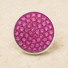 round snap jewelry charm covered with multiple bright pink rhinestones set in a silver-tone metal base