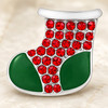 Christmas stocking snap jewelry charm with green enamel toe and heel sections and red rhinestones covering the upper part
