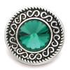 Round SnapAccents snap jewelry charm with intricate silver swirl design and large faceted emerald green crystal center, decorative interchangeable button accessory for bracelets and necklaces.
