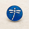 round snap jewelry charm with a silver dragonfly on a blue chevron enamel background