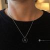 silver necklace with a round black snap jewelry charm featuring a polished silver letter A on a ball chain