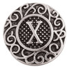 SnapAccents silver-tone snap jewelry charm with ornate scrollwork design and raised letter X centerpiece, decorative interchangeable button accessory for bracelets and necklaces.