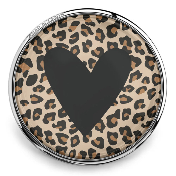 SnapAccents snap jewelry charm with black heart design on beige and brown leopard print background, round interchangeable snap button accessory for bracelets and necklaces, trendy animal print fashion jewelry piece.