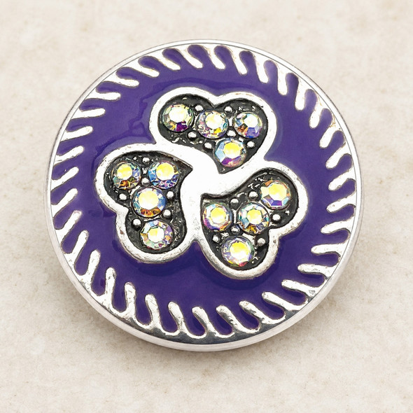 18MM purple snap jewelry charm with three interlocking hearts decorated with sparkling rhinestones and a silver swirl border