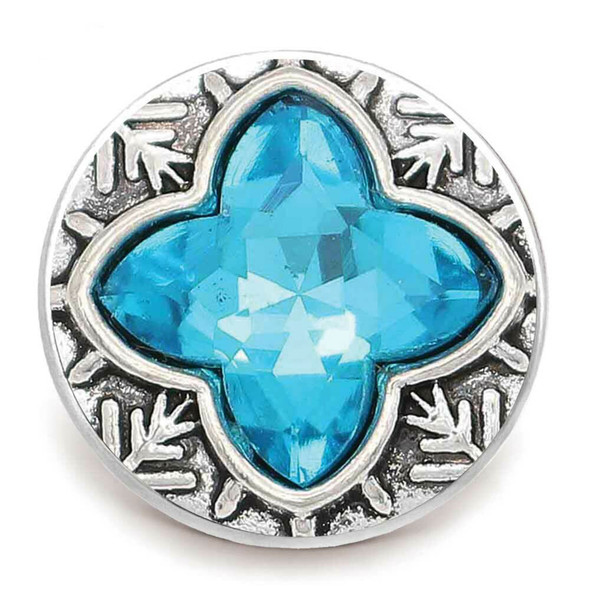 round snap jewelry charm with a faceted blue four-point rhinestone center and textured silver-tone background with leaf-like accents