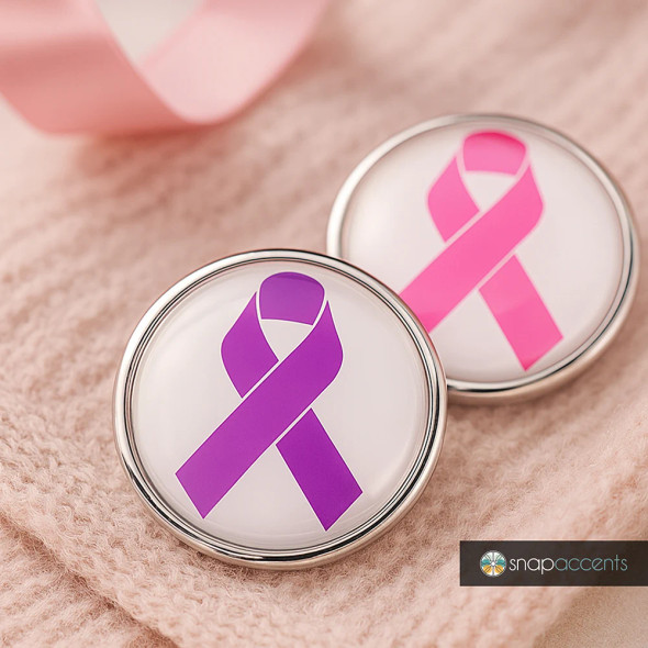 SnapAccents snap jewelry featuring interchangeable purple and pink awareness ribbon snaps, perfect for customizable bracelets or accessories, displayed on a soft beige knit fabric background.