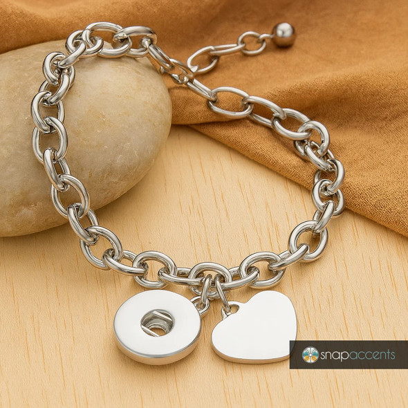 Silver chain link bracelet with interchangeable snap charms, featuring a round donut and heart-shaped charm, stylish customizable jewelry accessory by SnapAccents.