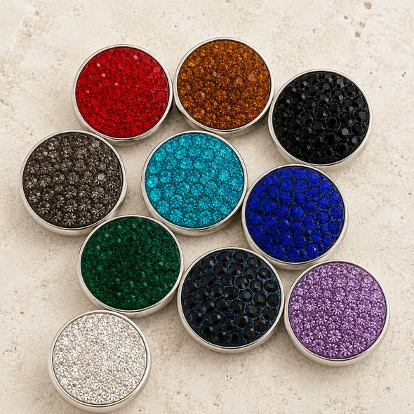 Colorful SnapAccents snap jewelry buttons featuring textured, circular designs in red, orange, black, brown, turquoise, blue, green, and clear, perfect for interchangeable fashion accessories and customizable jewelry pieces.