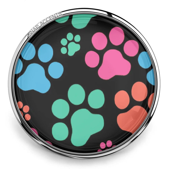 SnapAccents snap jewelry charm with colorful paw prints in blue, pink, green, and orange on a black background, perfect for pet lovers and customizable snap accessories.