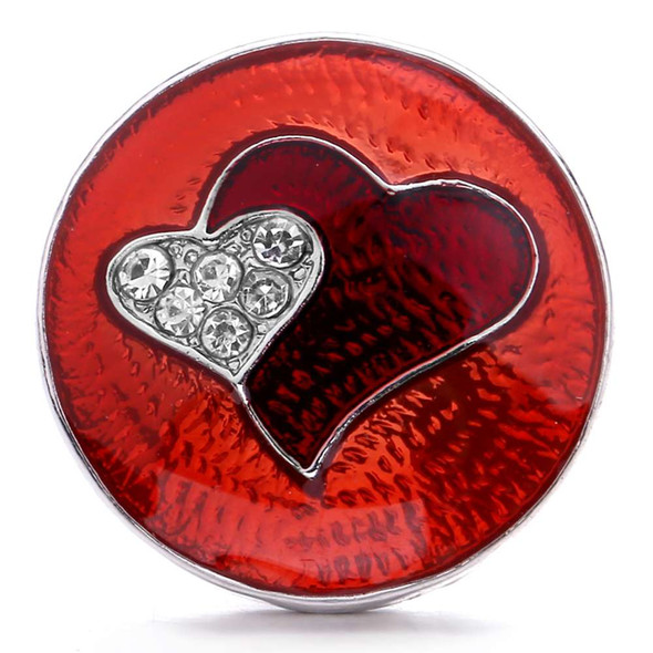 Red SnapAccents snap jewelry charm with two overlapping hearts, one encrusted with clear rhinestones, set on a textured red enamel background, perfect for interchangeable snap bracelets and accessories.
