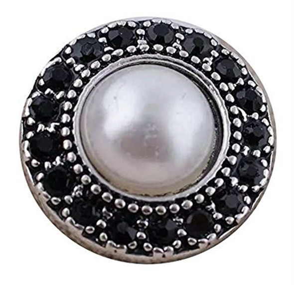 round snap jewelry charm with a white pearl center surrounded by a circle of black rhinestones in a silver-tone setting