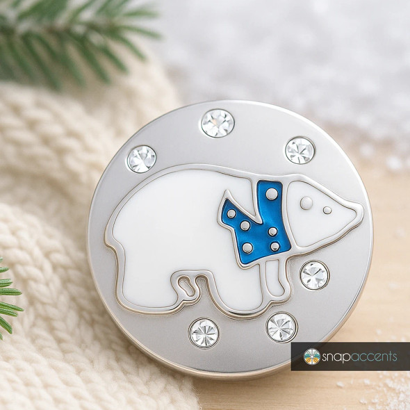 SnapAccents round snap jewelry charm featuring a white polar bear with a blue scarf design, accented with clear rhinestones on a silver-tone metal base, perfect for interchangeable snap bracelets, necklaces, and accessories.