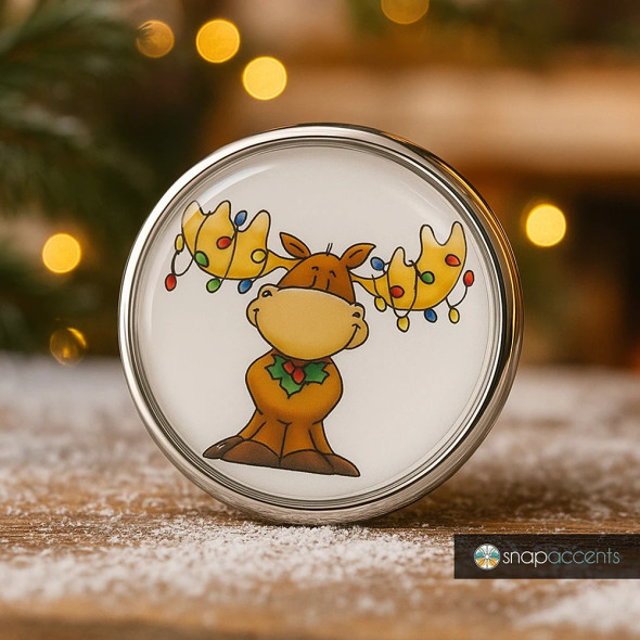 SnapAccents holiday snap jewelry featuring a cute cartoon moose with colorful Christmas lights wrapped around its antlers, festive holly decoration, silver metal frame, perfect for seasonal accessories, gift ideas, and winter-themed fashion accents.