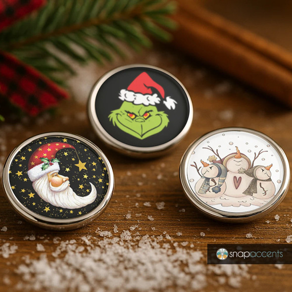 SnapAccents holiday snap jewelry set featuring interchangeable snaps with festive designs including the Grinch in a Santa hat, a whimsical Santa face with stars, and a cute trio of snowmen, perfect for Christmas-themed accessories and gifts.