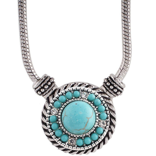 silver metal toggle necklace with a round snap jewelry charm featuring a central turquoise stone surrounded by smaller turquoise beads and clear rhinestones