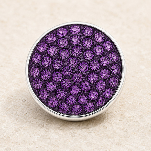round snap jewelry charm covered with multiple faceted purple rhinestones set in a silver-tone metal base