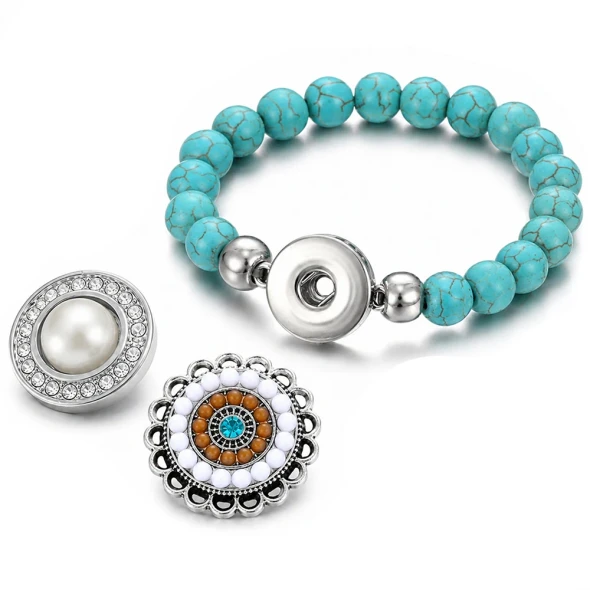 Turquoise beaded snap bracelet with silver snap button base, accompanied by two interchangeable snap jewelry charms—one with a pearl center surrounded by clear crystals, and a decorative round charm featuring white, brown, and turquoise stones in a silver filigree setting, perfect for customizable fashion accessories.