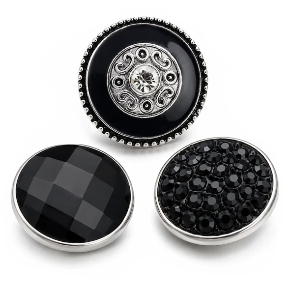 SnapAccents black snap jewelry set featuring three interchangeable round snaps: one with intricate silver swirl design and central clear rhinestone, one with smooth faceted black stone, and one with textured black rhinestone cluster, all with silver-tone metal edges, perfect for customizable fashion accessories.