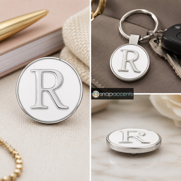 round snap jewelry charm with a white enamel background and a raised silver letter R, shown loose and attached to a keychain