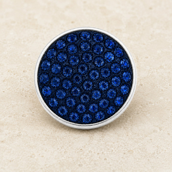 round snap jewelry charm covered with multiple deep navy blue rhinestones set in a silver-tone metal base