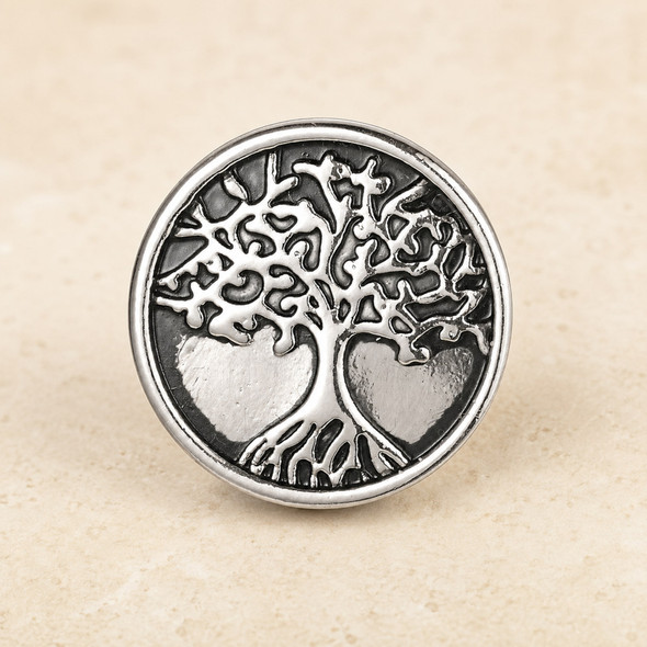 round silver snap jewelry charm with a raised Tree of Life design featuring intricate branches and roots on a textured dark background