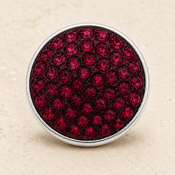round snap jewelry charm covered with multiple maroon rhinestones set in a silver-tone base