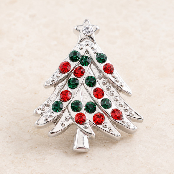 Small silver snap jewelry charm shaped like a Christmas tree with red and green rhinestones and a clear rhinestone star at the top