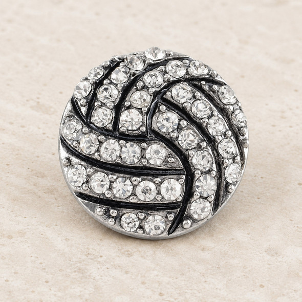 18mm round snap jewelry charm with a volleyball design covered in clear rhinestones on a silver-tone base