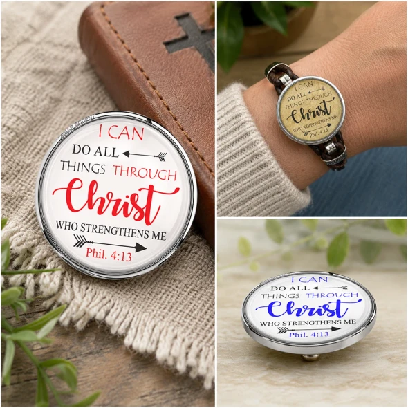 SnapAccents snap jewelry featuring inspirational Bible verse "I can do all things through Christ who strengthens me" Phil. 4:13, two interchangeable snap charms with white and gold backgrounds, displayed with a silver cross necklace on a tan surface.