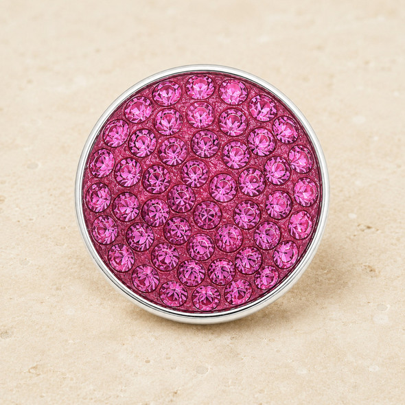 round snap jewelry charm covered with multiple bright pink rhinestones set in a silver-tone metal base