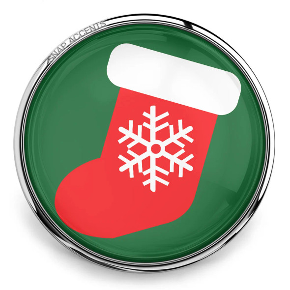 SnapAccents Christmas stocking snap charm with red stocking, white cuff, and white snowflake design on green background, silver metal frame, festive holiday jewelry accessory.