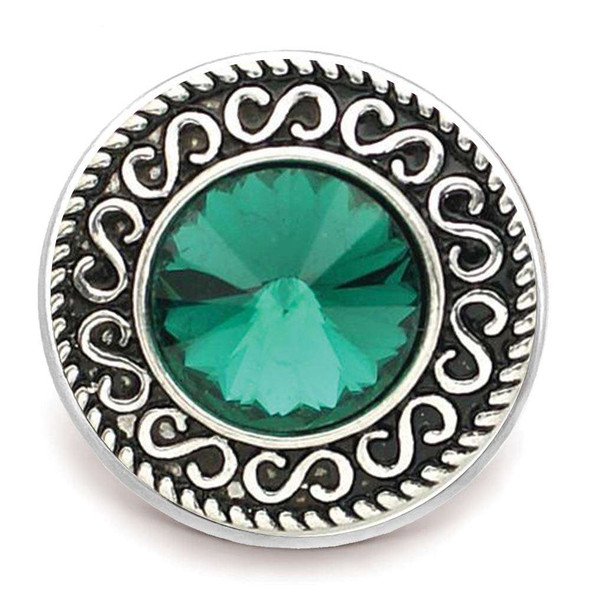 Round SnapAccents snap jewelry charm with intricate silver swirl design and large faceted emerald green crystal center, perfect for interchangeable snap bracelets, necklaces, and accessories.