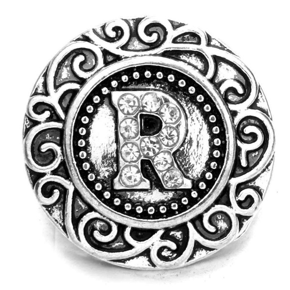 SnapAccents silver-tone snap jewelry charm with ornate scroll design and rhinestone-studded letter "R" centerpiece, decorative interchangeable accessory for bracelets and necklaces.