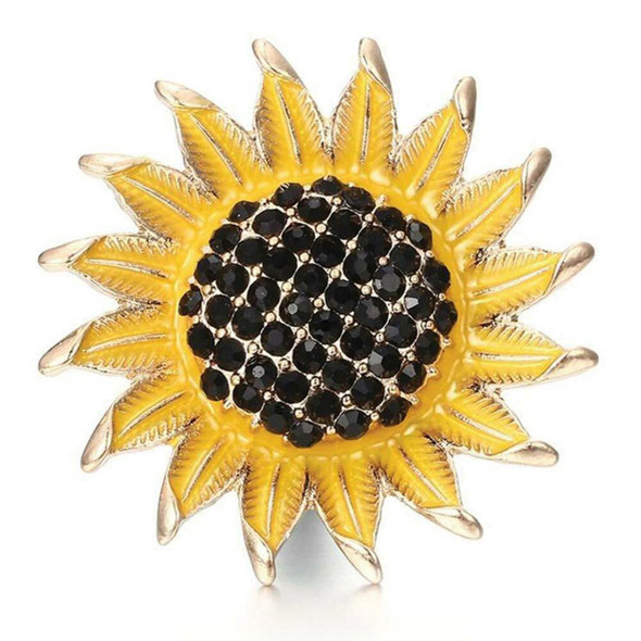 snap jewelry charm shaped like a sunflower with bright yellow enamel petals tipped in gold and a center filled with clustered black rhinestones