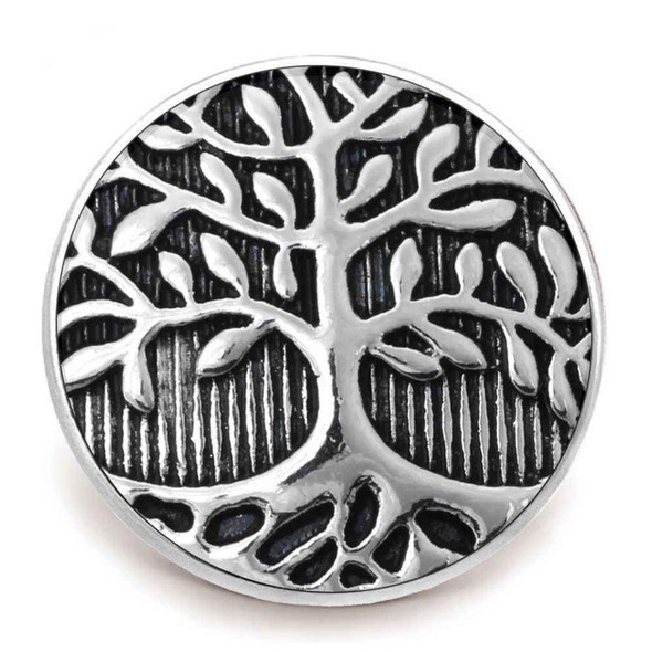 round silver snap jewelry charm with a tree and roots design on a black striped background
