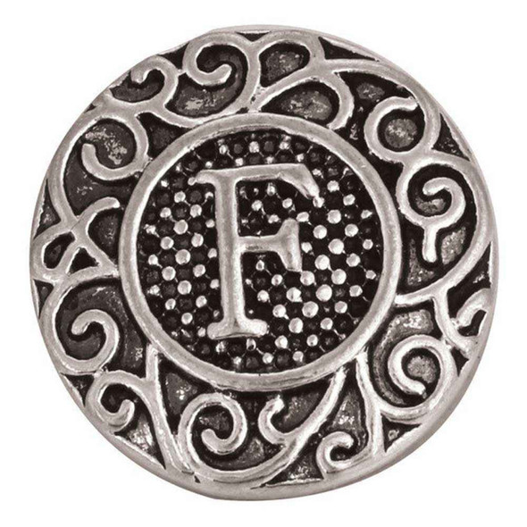 round silver snap jewelry charm with a raised letter F in the center and intricate filigree scrollwork around the edge