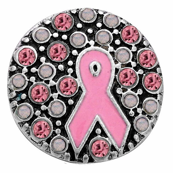 round snap jewelry charm with a pink enamel breast cancer ribbon center surrounded by alternating pink and clear rhinestones on a silver-tone base