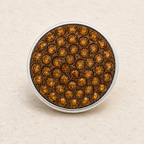 round snap jewelry charm covered with multiple faceted brown rhinestones set in a silver-tone metal base