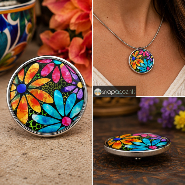 18mm snap jewelry charm with a colorful watercolor daisy floral design in orange, pink, blue, purple, and yellow on a black background
