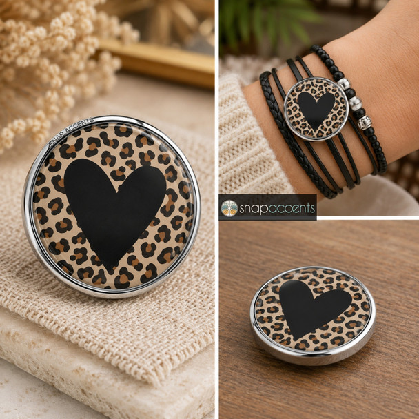 18mm snap jewelry charm with a black heart on a brown and black animal print background in a silver-tone metal base, shown loose and on a black multi-strand bracelet