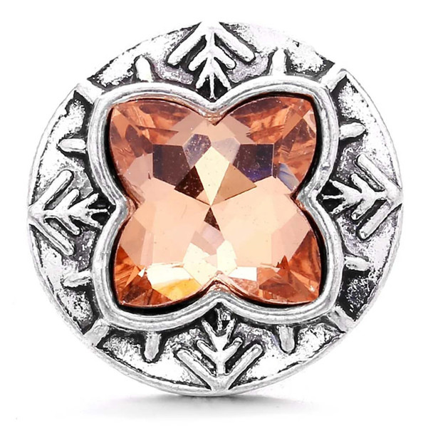 snap jewelry charm with a light brown four-point rhinestone set in a round silver-toned base with decorative arrow-like accents