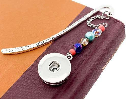 Silver snap jewelry bookmark with colorful beads including blue, turquoise, coral, and crystal accents, featuring a decorative engraved handle and a snap button charm for interchangeable jewelry pieces.
