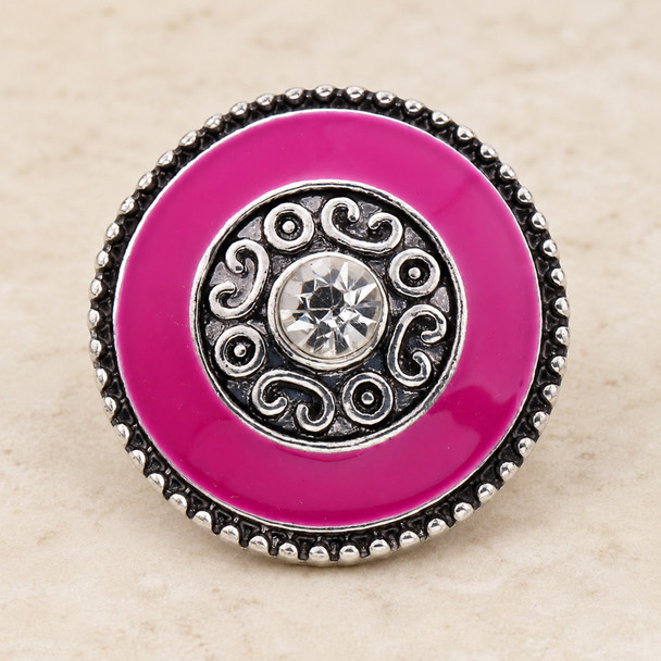 round pink snap jewelry charm with silver scroll detailing and a clear rhinestone center