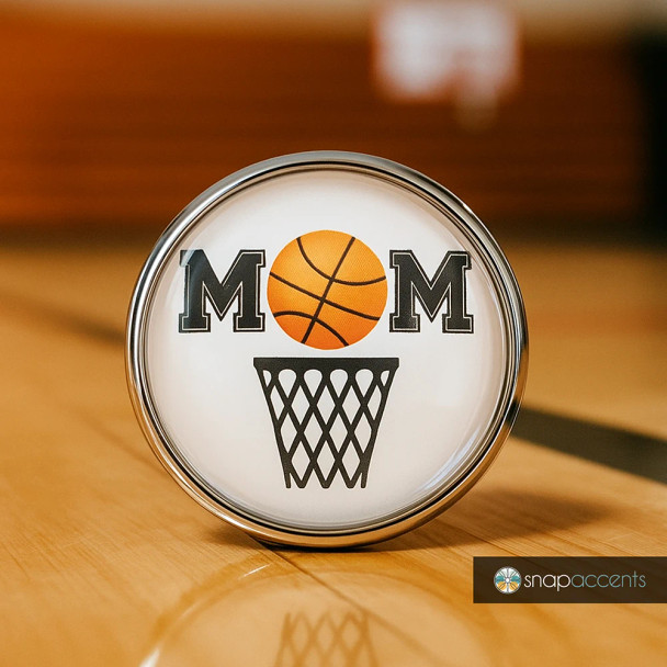 Round SnapAccents snap jewelry charm with "MOM" design featuring a basketball replacing the "O" and a basketball hoop graphic below, perfect for basketball moms, sports fans, and personalized snap jewelry collections.
