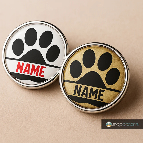 SnapAccents customizable snap jewelry featuring black paw print design on white and gold backgrounds with bold "NAME" text, perfect for pet lovers, interchangeable snap charm accessories, stylish and personalized gift idea.