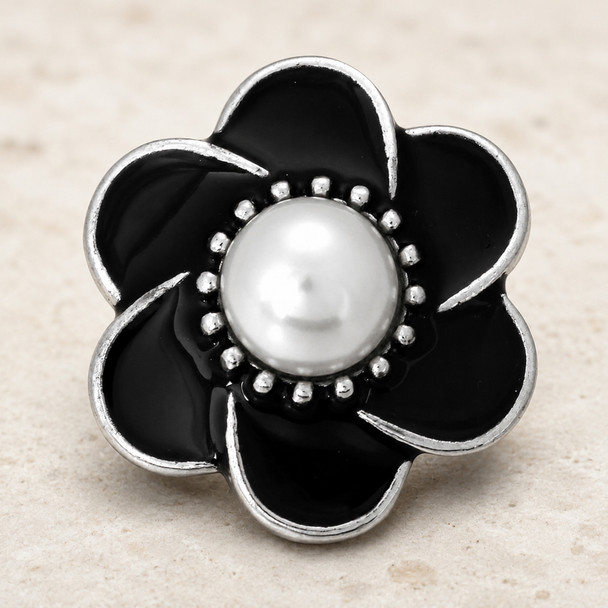black enamel flower snap jewelry charm with silver edges and a white pearl center