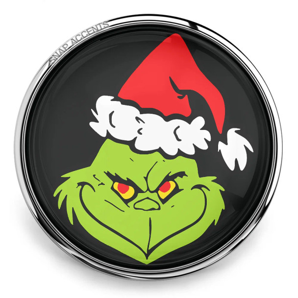 SnapAccents snap jewelry charm featuring a green Grinch face with red and yellow eyes wearing a red and white Santa hat on a black background, perfect for holiday-themed interchangeable snap jewelry accessories.