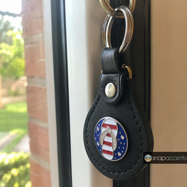 Black leather keychain with a snap jewelry charm featuring a blue background and a rhinestone-accented red and white striped flip flop sandal