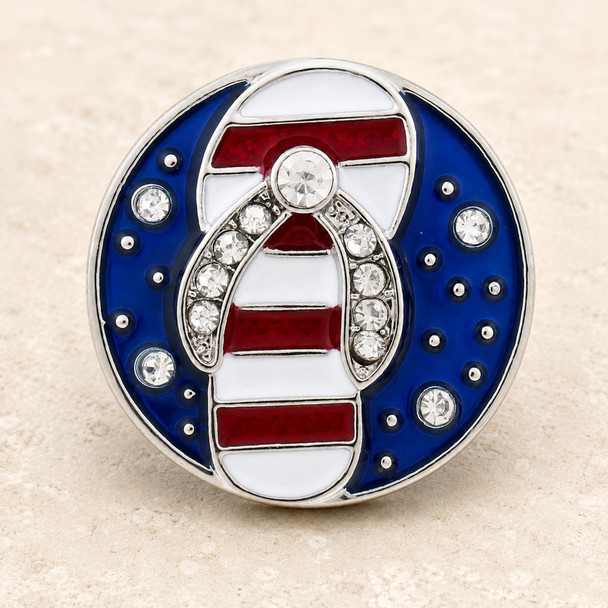 Round snap jewelry charm with a blue enamel background, rhinestones, and a red and white striped flip flop sandal accented with clear rhinestones