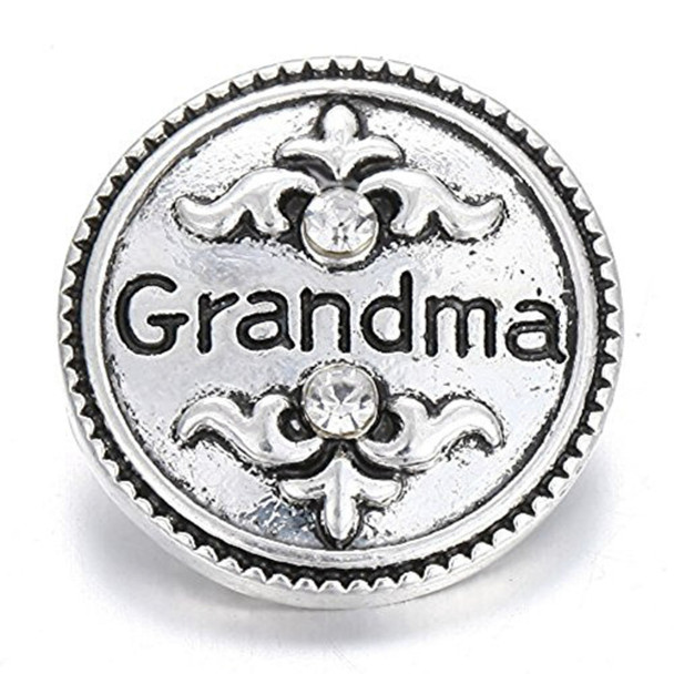 Silver snap jewelry charm with the word Grandma in black and two clear rhinestones above and below decorative flourishes